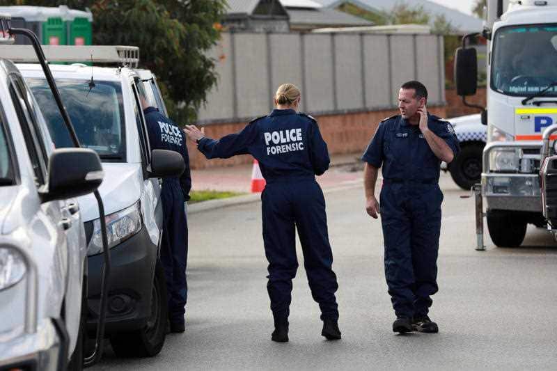 Forensic police at a house where three people have been found dead in Perth.