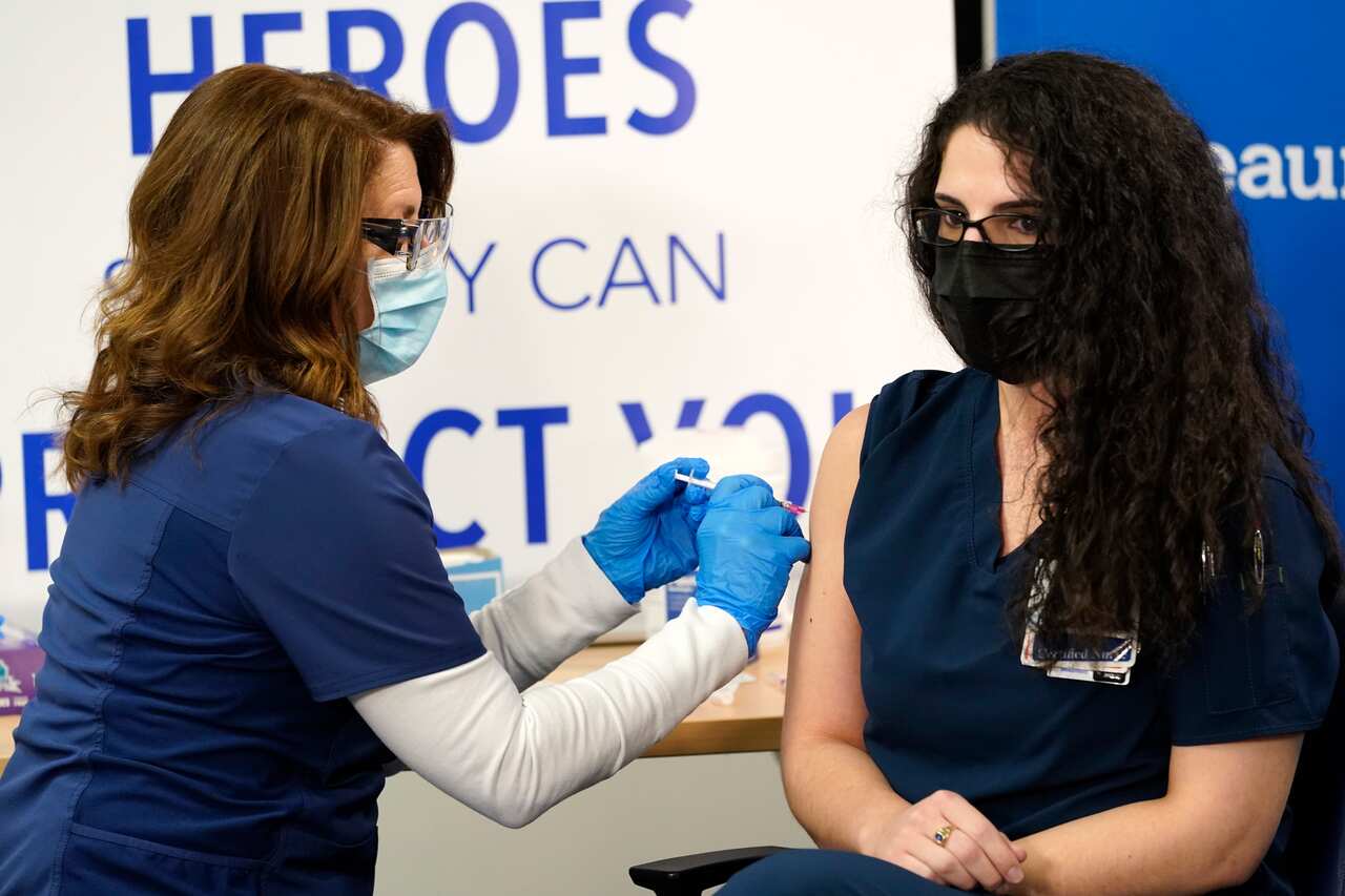 Paula Levesque administers a second Pfizer-BioNTech COVID-19 vaccine