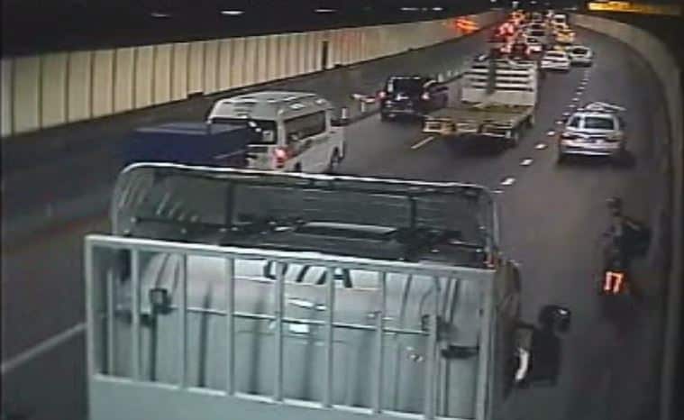 A truck approaches a food delivery cyclist in Sydney’s Eastern Distributor tunnel.
