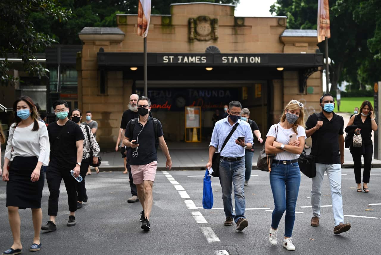 Commuters wearing face masks exit St James Station in Sydney's CBD on Monday, January 4, 2021.