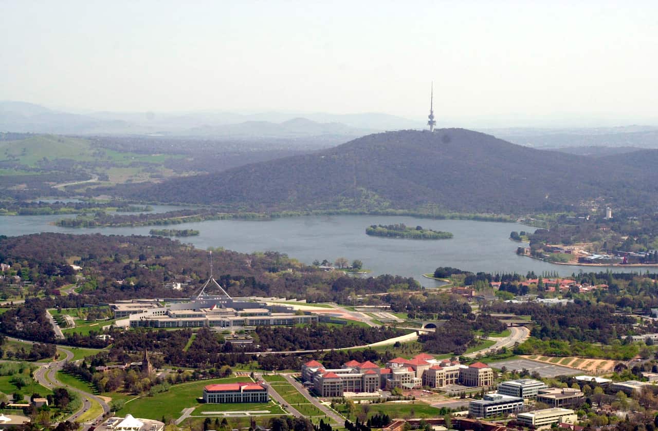 Canberra: Overlooking Dept. of Foreign Affairs (bottom centre) and Parliament House with Lake Burley Griffin and Black Mountain in the background.