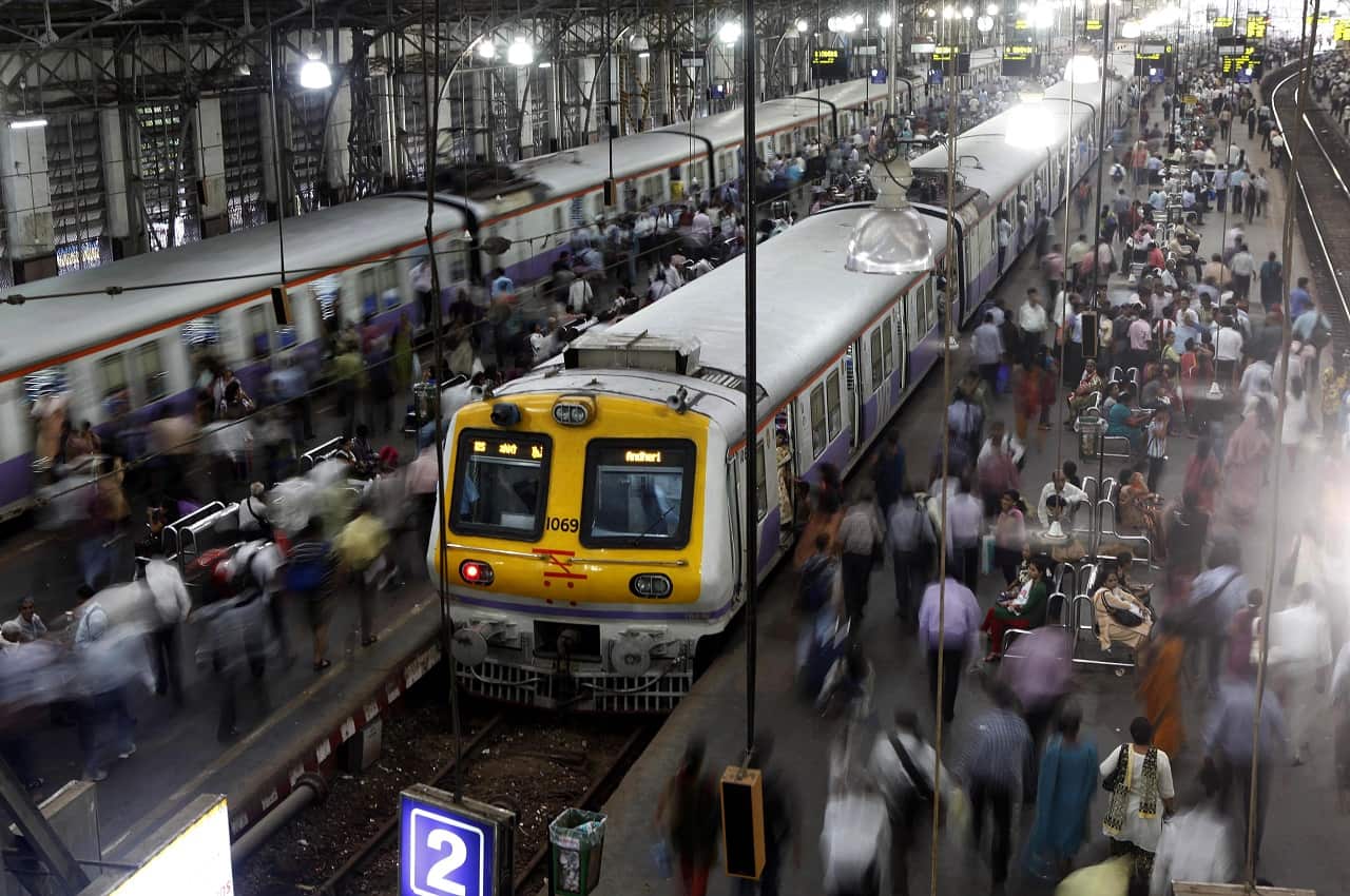 Indian commuters walk at the Churchgate railway station in Mumbai.