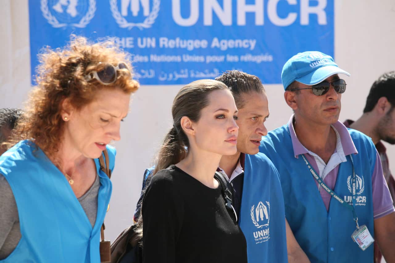 The U.N. refugee agency's special envoy, actress Angelina Jolie, center, arrives to the Zaatari Refugees Camp in Jordan for Syrians who fled the civil war in their country, Tuesday, Sept. 11, 2012. Jolie said Tuesday she heard "horrific" and "heartbreakin