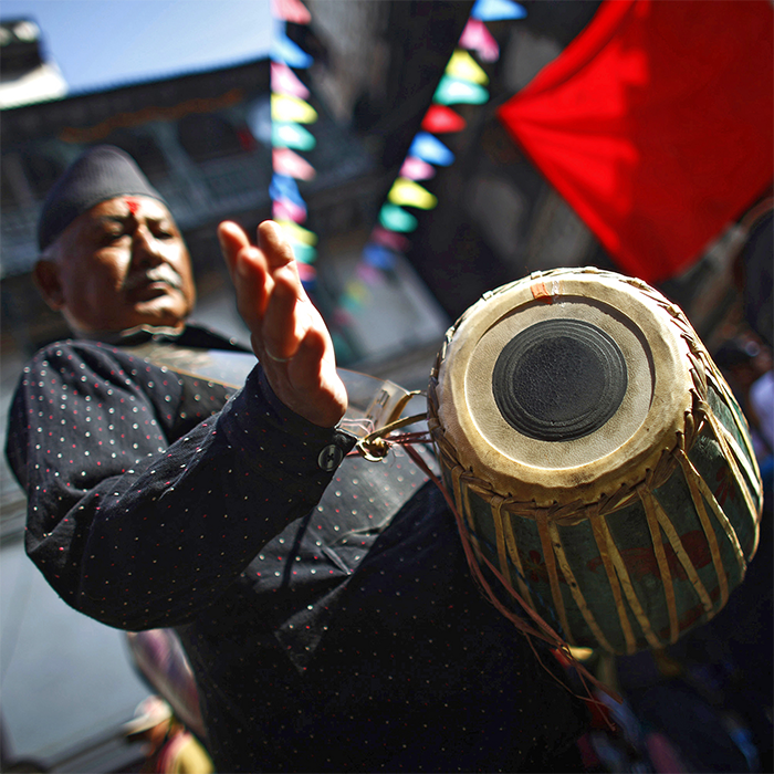 A Nepalese ethnic Newari beats a from and participates in a parade to celebrate their New Year in Katmandu, Nepal, Wednesday. Nov 14, 2012. Members of the Newar Community celebrate their New Year's Day by performing rituals to purify and empower the soul
