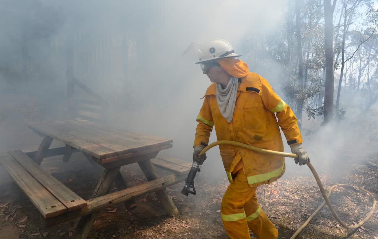 Rural Fire Service (RFS) volunteers fight to contain an out of control fire at Winmalee in the Blue Mountains west of Sydney