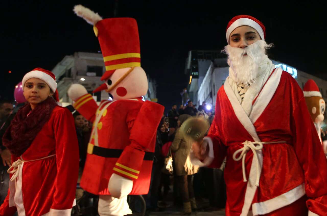 Palestinian Christians take part in a Christmas parade in the West Bank city of Ramallah, 22 December 2016
