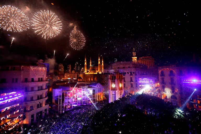 Fireworks explode over the downtown of Beirut, Lebanon, during New Year's Eve celebrations, Monday, Jan. 1, 2018. (AP Photo/Hussein Malla)