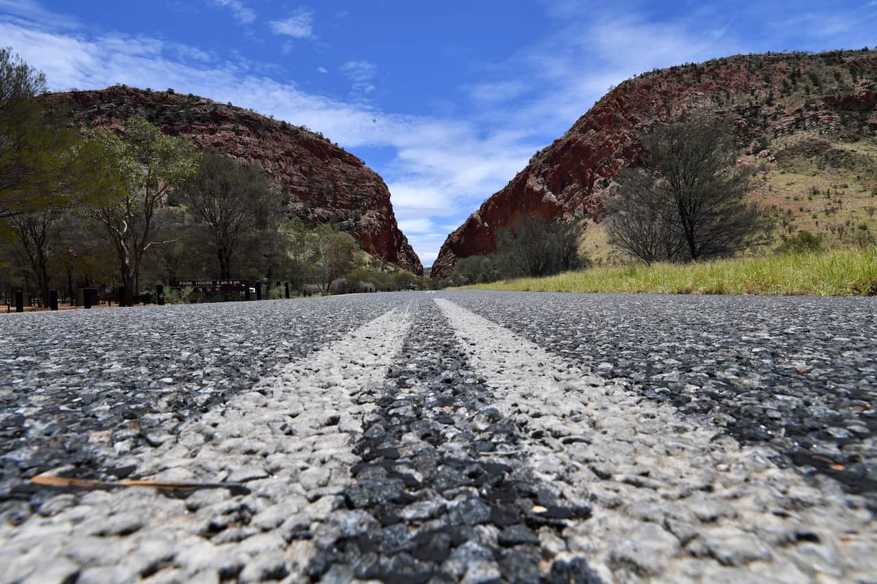 A general view of the road leading towards Simpsons Gap, which is situated in the West MacDonnell Ranges, near the Northern Territory city of Alice Springs, Sunday, January 14, 2018. (AAP Image/Darren England) NO ARCHIVING