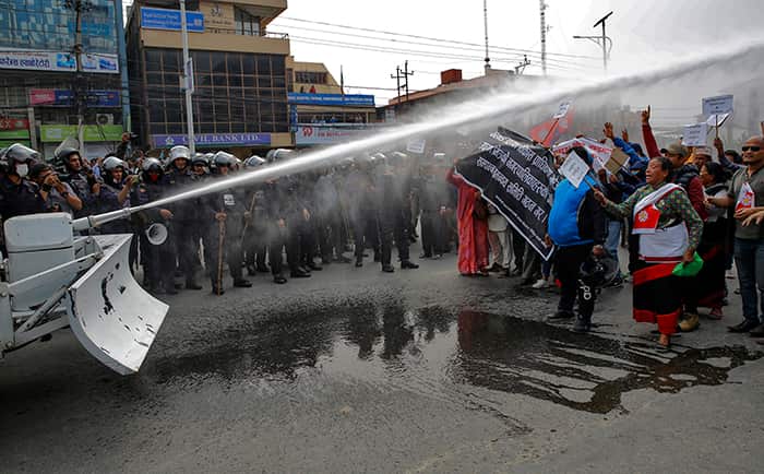 epaselect epa06633866 Riot policemen use water cannon against local residents of Kathmandu valley during an anti-government protest rally in Kathamndu, Nepal, 28 March 2018.
