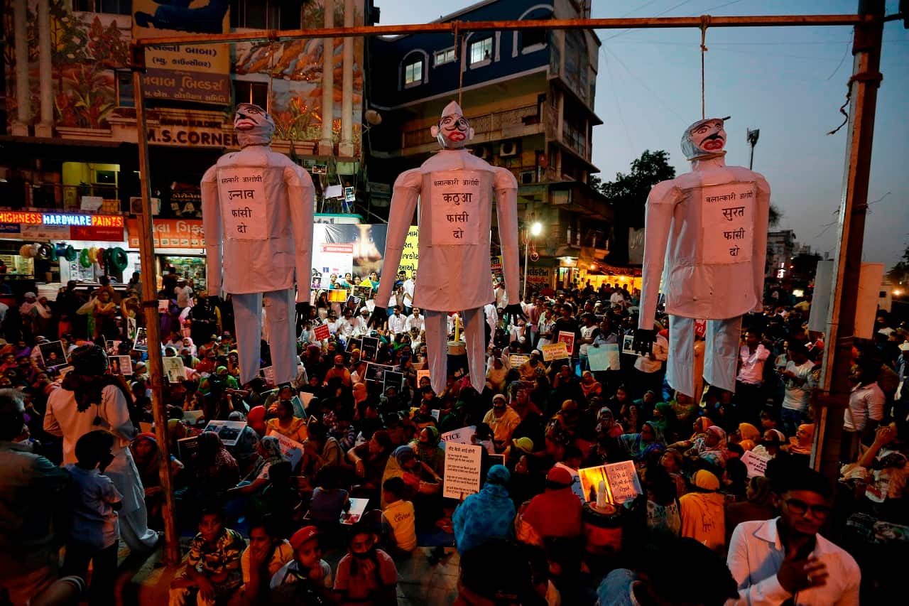 effigies hang on nooses with the words, "hang the guilty in the Unnao rape case," "Hang the guilty in Kathua rape case," "hang the guilty in Surat rape case,