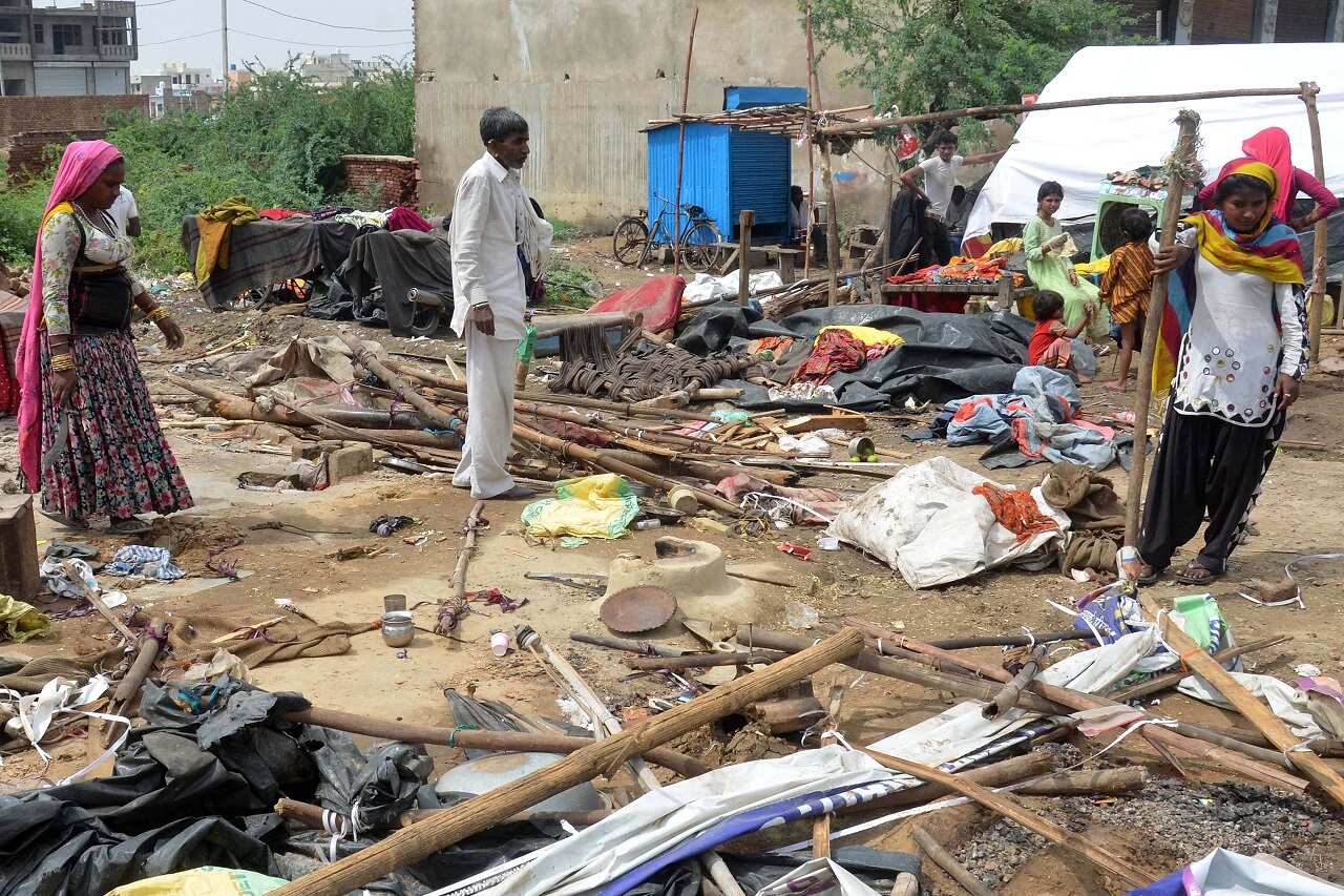 Residents stand amidst their damaged houses after a massive storm, near Bharatpur district of Rajasthan, India 03 May 2018.