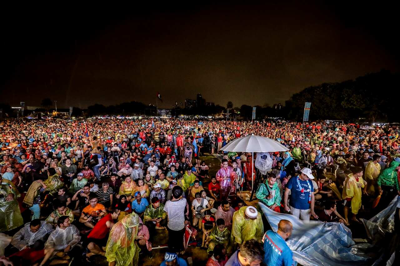 Supporters of former Malaysian strongman Mahathir Mohammad wait as rain pours during an election campaign in Kuala Lumpur,