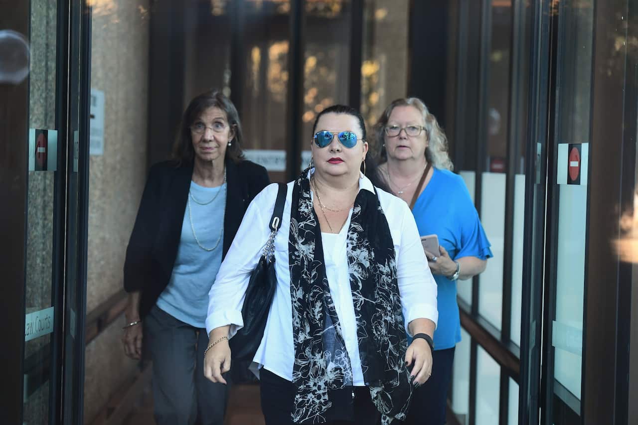 Michelle William, the sister of Christoper Greenfield, (left) Raymond James' daughter Tracy James (centre) and sister Marlaine Smith leave the NSW Supreme Court in Sydney