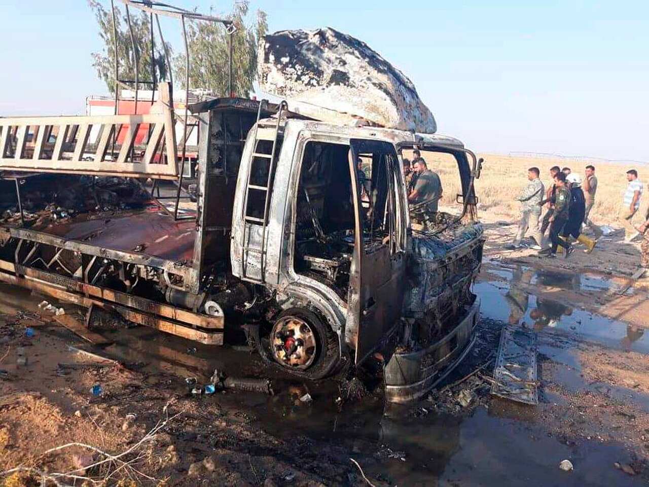 This photo released by Popular Mobilization Forces shows shows the aftermath of a drone attack near Qaim border crossing with Syria, in Anbar province, Iraq