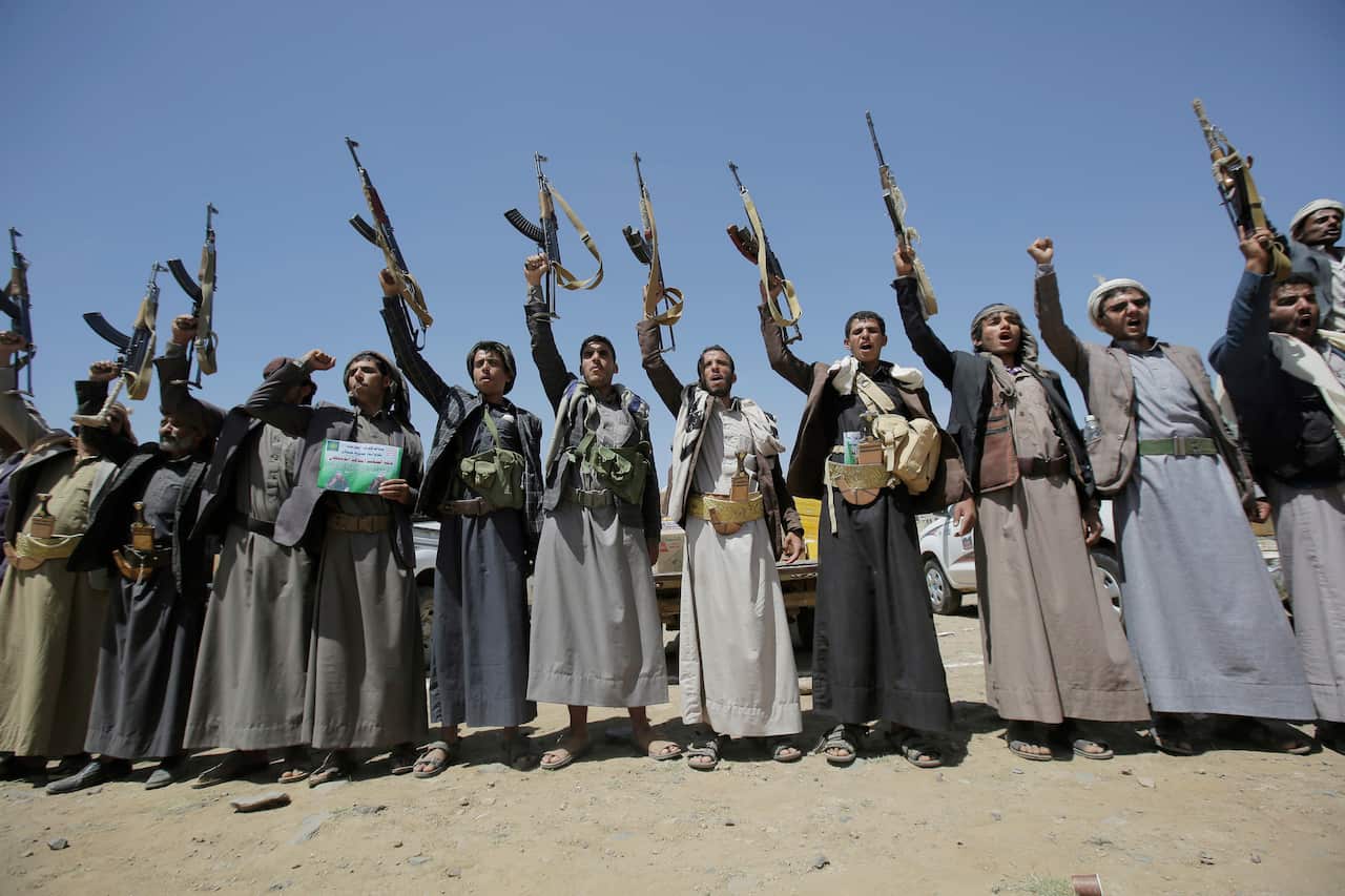 Shiite Houthi tribesmen hold their weapons as they chant slogans during a tribal gathering showing support for the Houthi movement, in Sanaa, Yemen