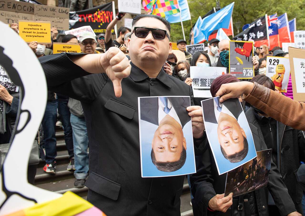 A Kim Jong-un impersonator is seen during a Hong Kong pro-democracy demonstration in Melbourne, Sunday, September 29, 2019. (AAP Image/Ellen Smith) NO ARCHIVING