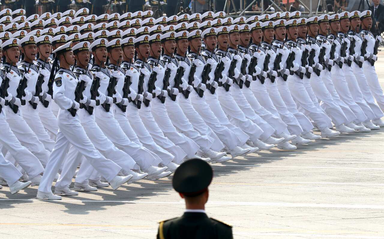 Chinese sailors march during a parade to commemorate the 70th anniversary of the founding of Communist China in Beijing, Tuesday, Oct. 1, 2019. (AP Photo/Ng Han Guan)