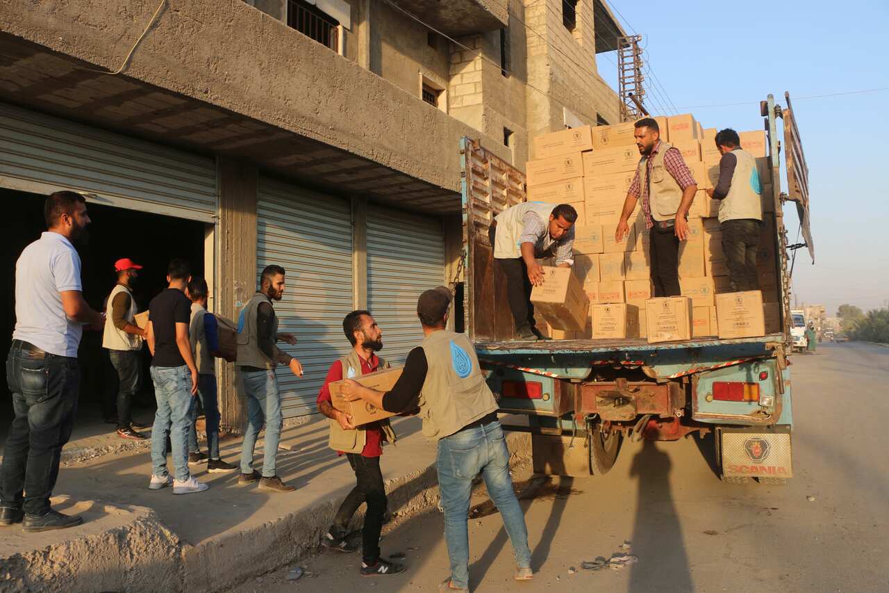 boxes of WFP-provided fortified date bars enriched with vitamins and minerals from a truck.Photo: WFP/Alan Ali