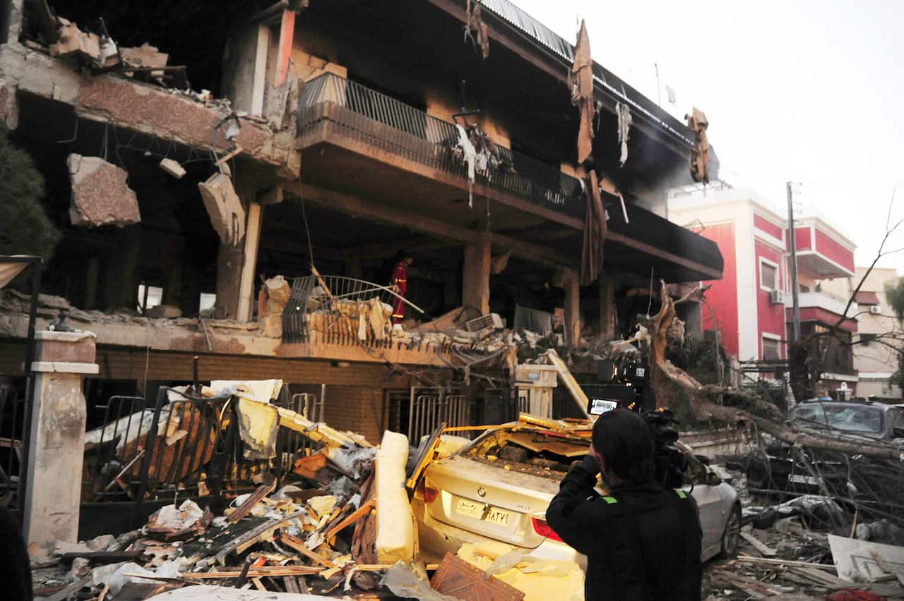 A cameraman films the damage of a building targeted by Israeli missile strikes in the early morning in the Mezzeh area in the capital Damascus, Nov. 12, 2019.