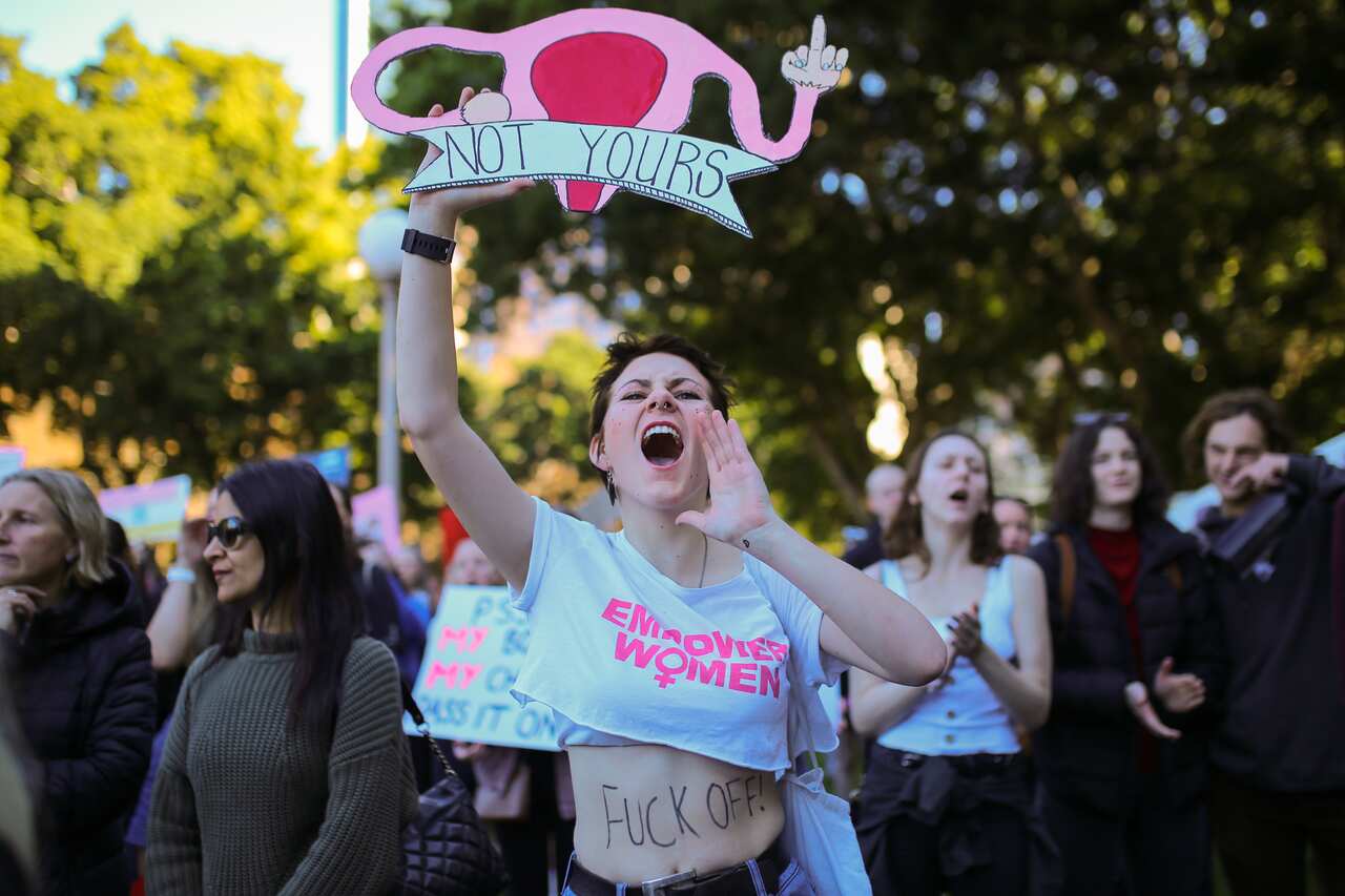 A protester chants while holding a placard during the Our Body Our Choice march in Sydney, Sunday, June 9, 2019.