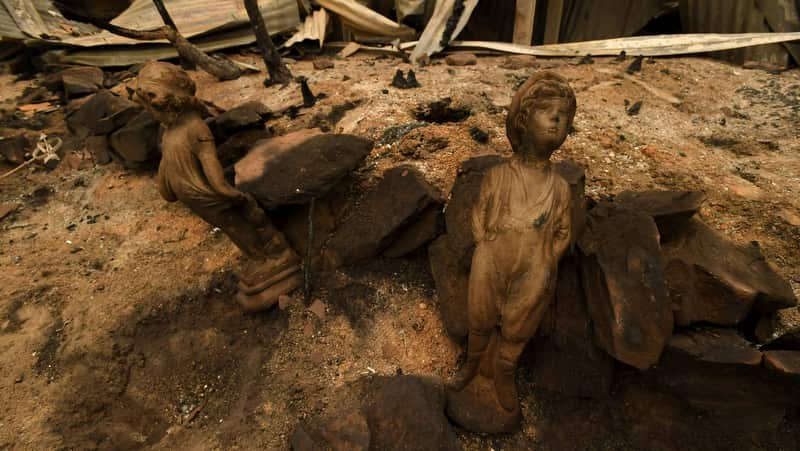 Burnt remains are seen as Prime Minister Scott Morrison tours the property of John 'Kooka' Kinniburgh, Sarsfield, Victoria.