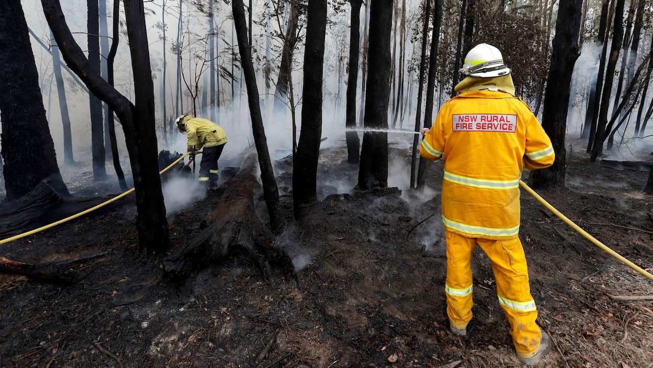 Firefighters manage a controlled burn near Tomerong, Australia.