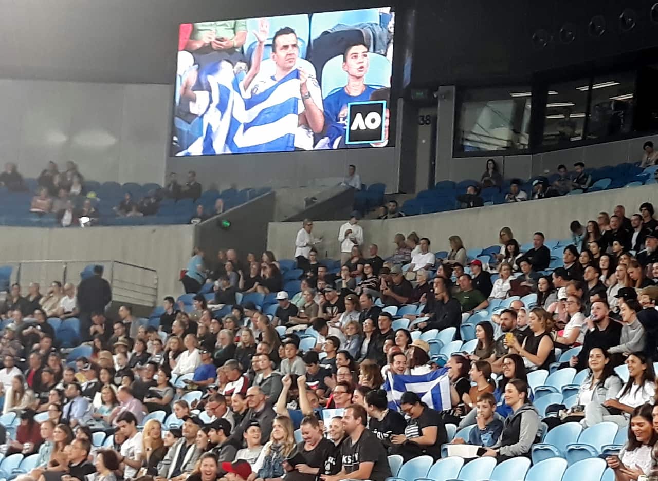 Fans cheer after Stefanos Tsitsipas' win on the first round at the Australian Open in Melbourne, 20 January 2020. 