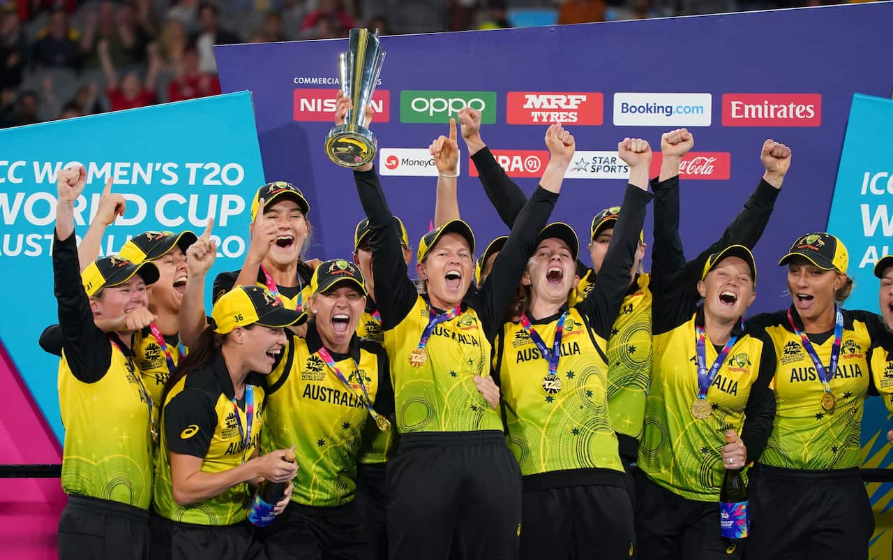 Meg Lanning of Australia and her teammates celebrate with the trophy after winning the Women's T20 World Cup final match between Australia and India at the MCG.