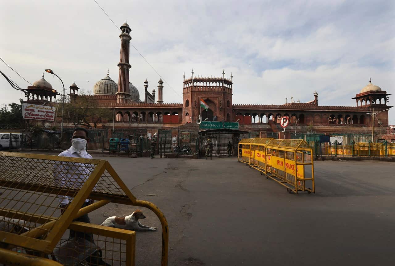 A civil defense volunteer keeps a vigil outside Jama Mosque to control coronavirus spread in New Delhi, India, Wednesday, March 25, 2020. 
