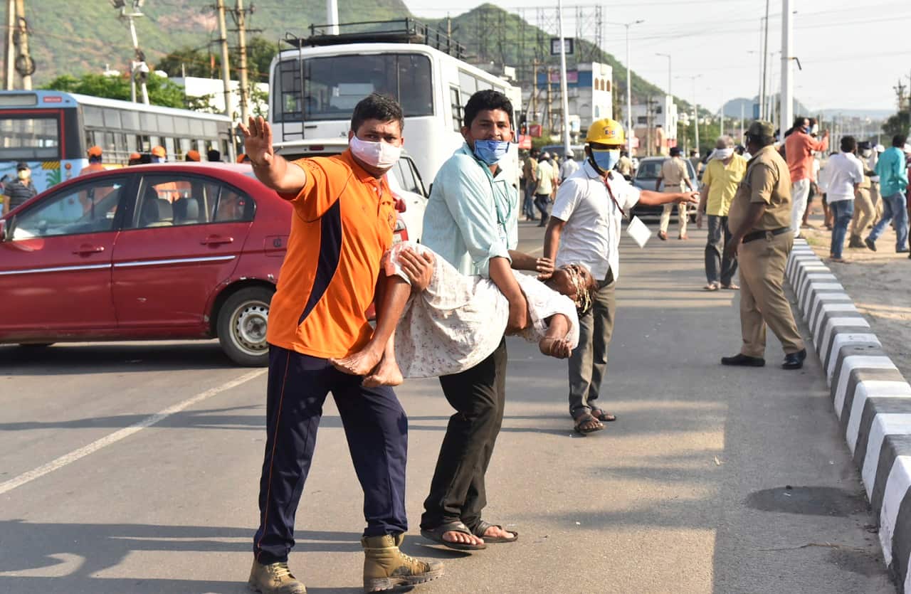 People carry a woman affected by a chemical gas leak in Vishakhapatnam, India, Thursday, May 7, 2020. Chemical gas leaked from an industrial plant in southern India early Thursday, leaving people struggling to breathe and collapsing in the streets as they