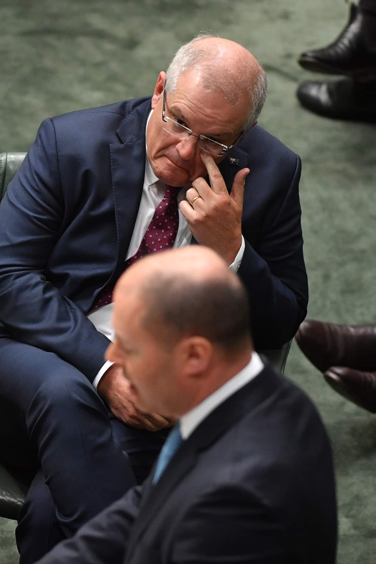 Prime Minister Scott Morrison listens to the Treasurer Josh Frydenberg making a ministerial statement to the House of Representatives at Parliament House in Canberra, Tuesday, May 12, 2020. (AAP Image/Mick Tsikas) NO ARCHIVING