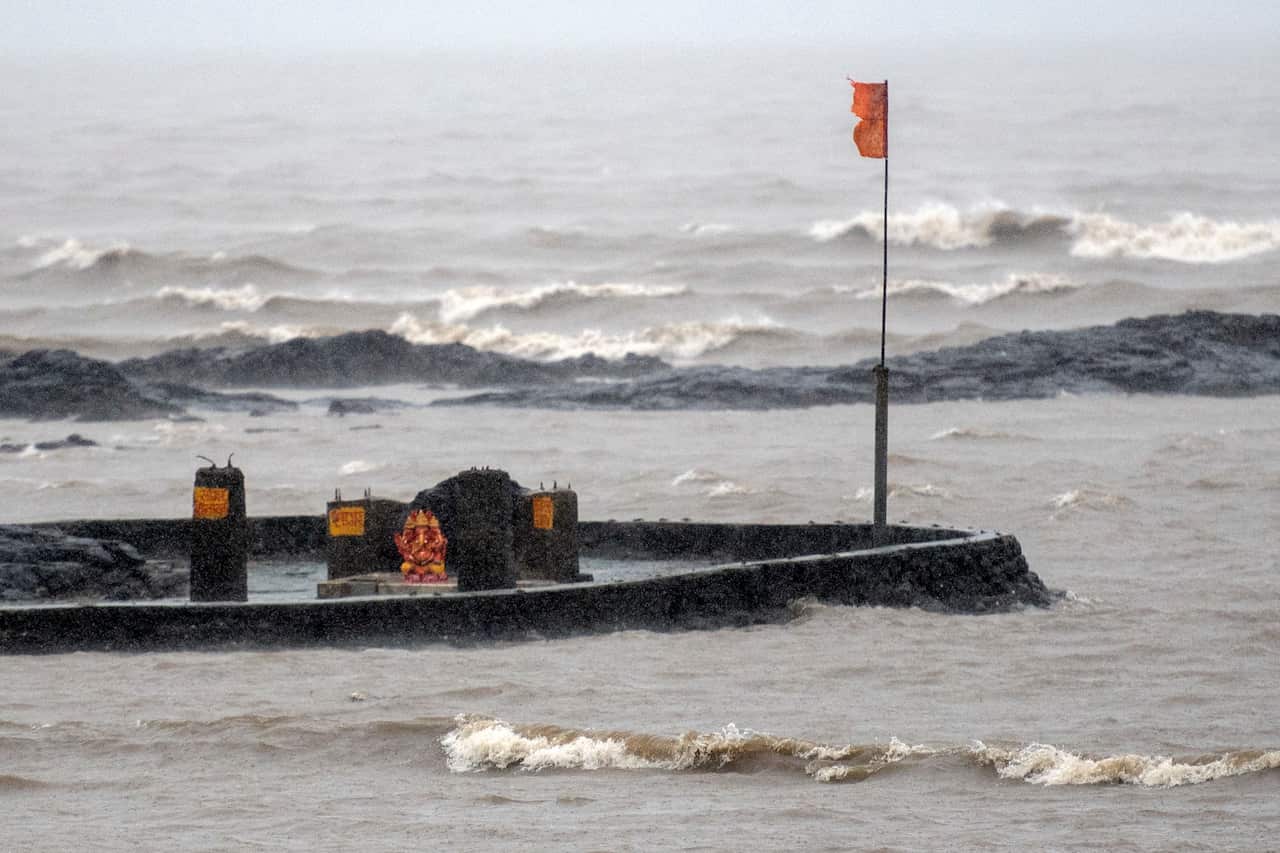 A lord Ganesha idol is seen surrounded by waves and heavy rain as as cyclone Nisarga barrels towards India's western coast at Carter Road