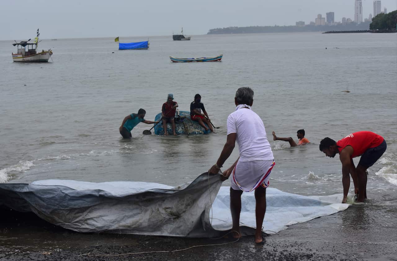 Residents and fisherman take precautionary measure before Nisarga Cyclone hits coastal line of Badhwar Park on June 3, 2020 in Mumbai, India.