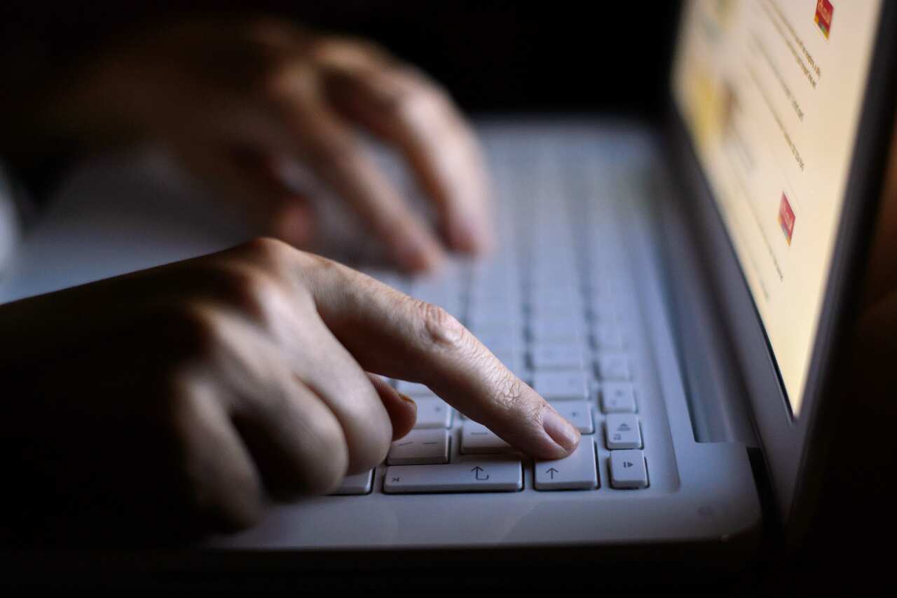 File photo dated 06/08/13 of a person using a laptop. Football fans have been urged to strengthen their cyber security settings as millions prepare to log-in to subscription services to watch the return of the Premier League.. Issue date: Wednesday June 1