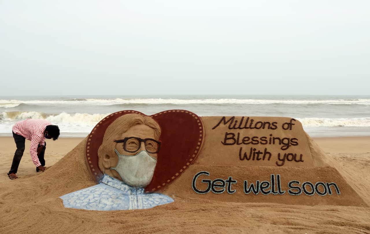 Indian sand artist Sudarsan Pattnaik touches up a sand sculpture of Indian Bollywood actor Amitabh Bachchan. 12 July 2020.