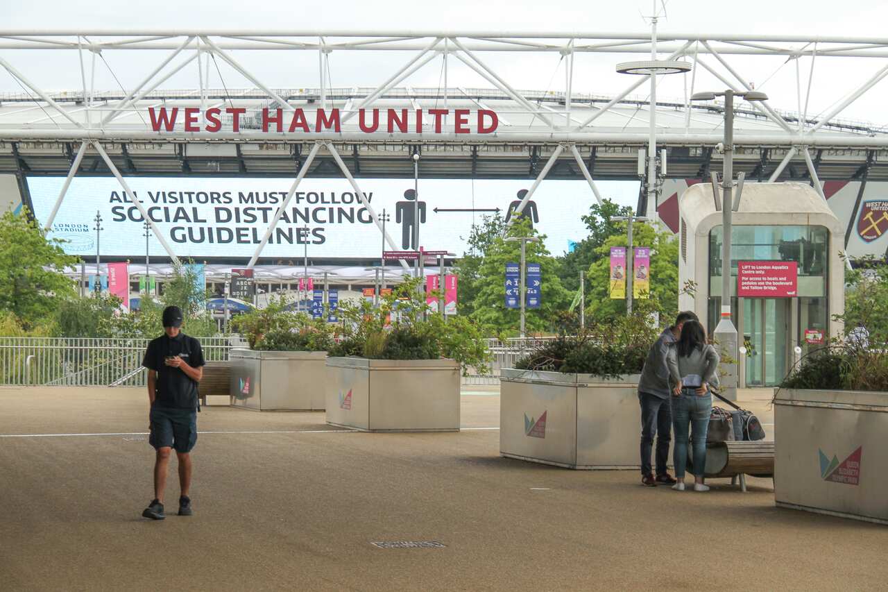 View of the West Ham United football stadium at the Queen Elizabeth Park informing all visitors to follow social distancing guidelines.
