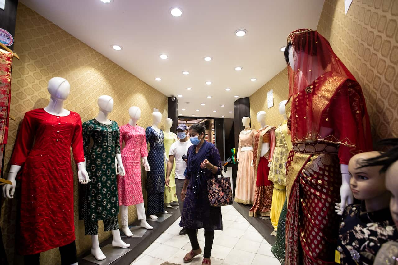 A woman wearing a face mask walks inside a reopened shopping mall, as the lockdown came to an end.