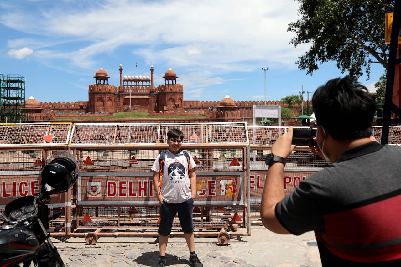 A visitor takes photographs at the Red Fort as preparation are underway on full swing ahead of upcoming Independence Day celebrations.