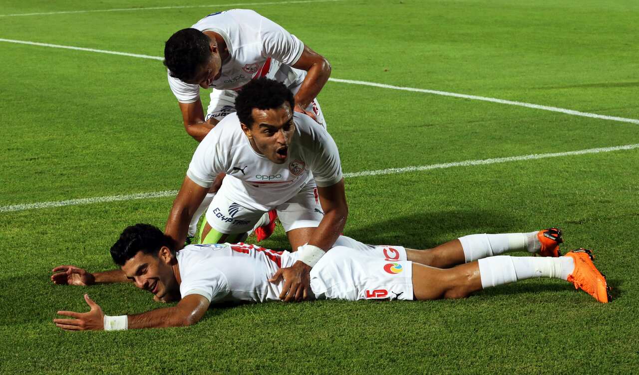 epa08619123 Zamalek's Zizo (bottom) celebrates with teammates after scoring the 1-0 lead during the Egyptian Premier League soccer match between Zamalek SC and Al Ahly SC in Cairo, Egypt, 22 August 2020.  EPA/KHALED ELFIQI