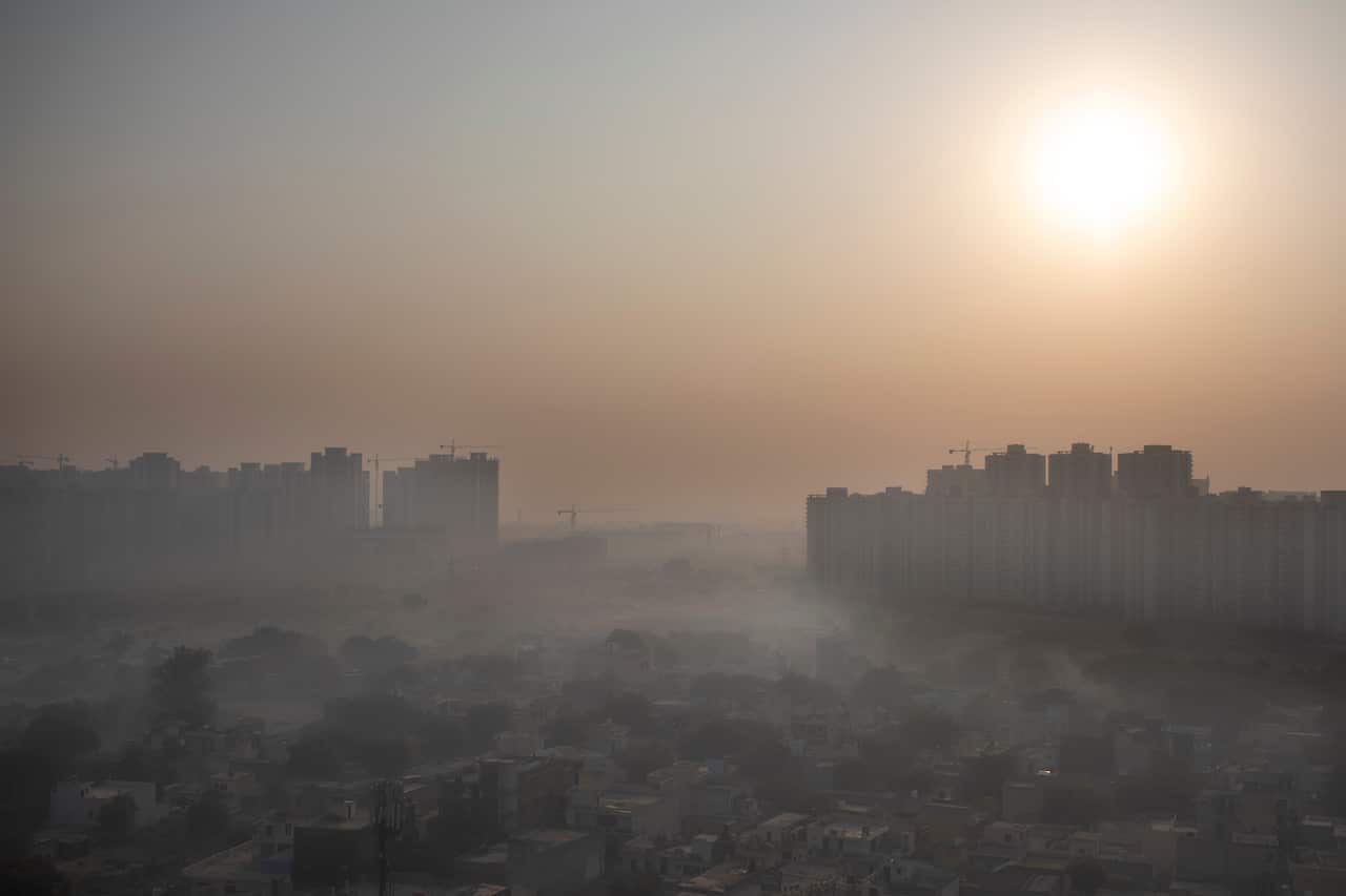 Morning haze envelops the skyline on the outskirts of New Delhi, India, Friday, Oct. 16, 2020.