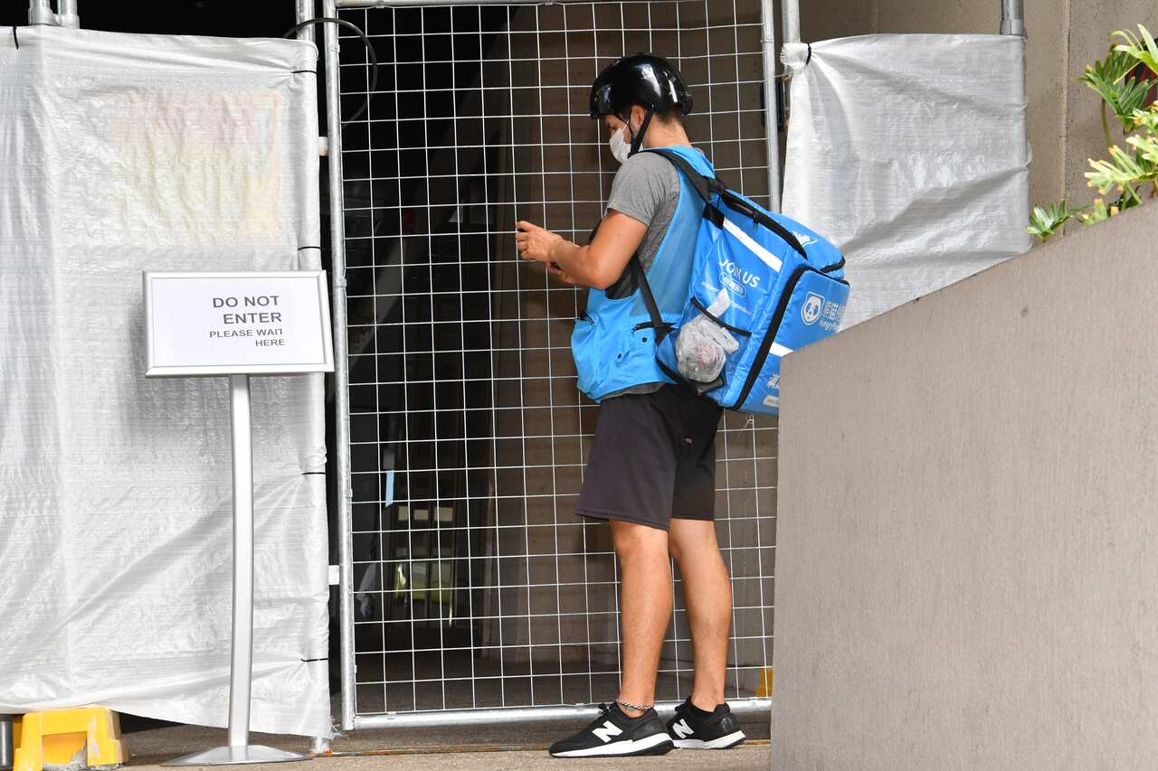 A food delivery man is seen outside the Sofitel Hotel after the Australian and Indian cricket teams arrived in Brisbane