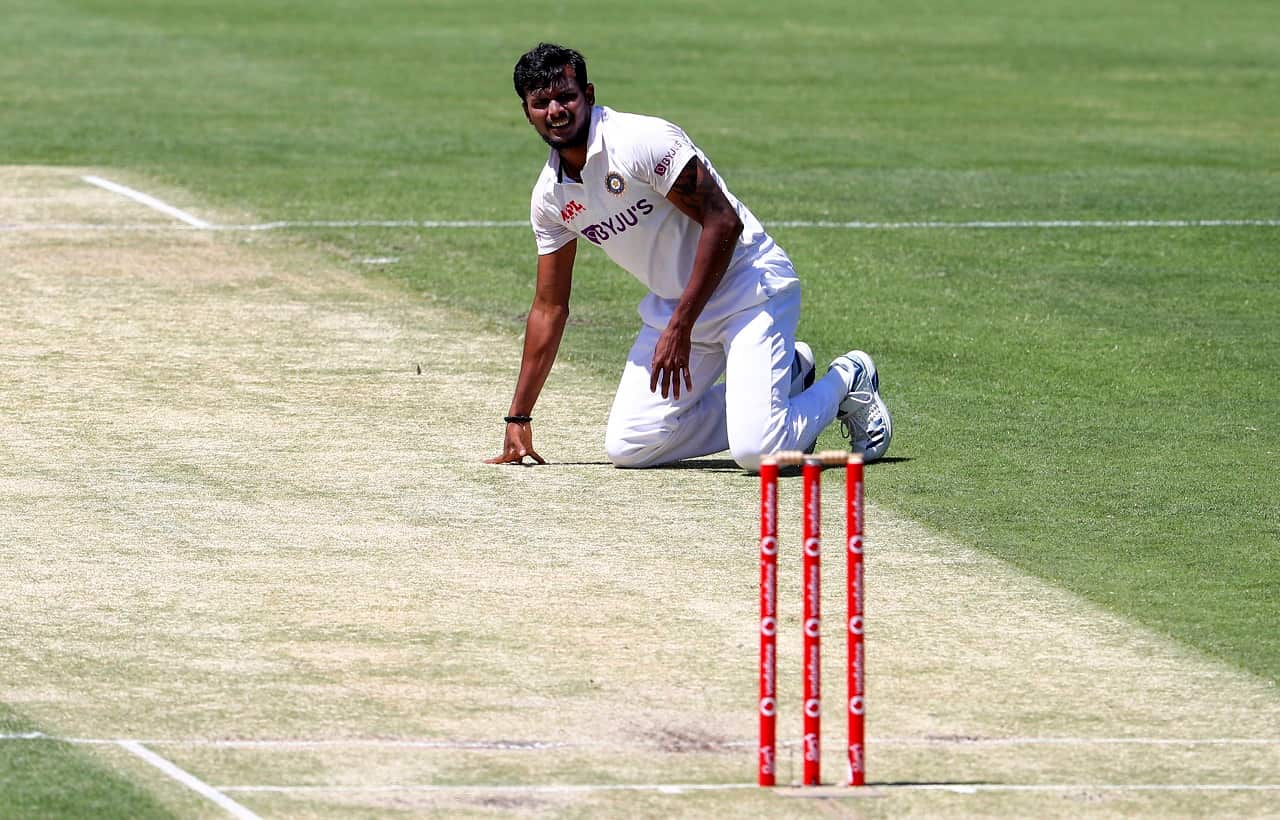 India's Thangarasu Natarajan falls onto the pitch during play on day two of the fourth cricket test between India and Australia at the Gabba, Brisbane, Australia, Saturday, Jan. 16, 2021. (AP Photo/Tertius Pickard)