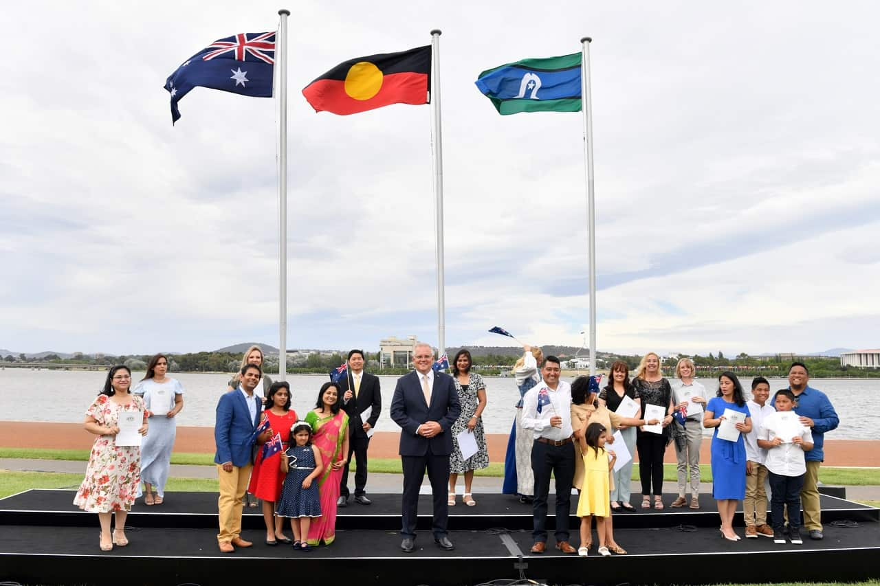 PM Scott Morrison poses for a photo with new citizens in Canberra, Tuesday, January 26, 2021.