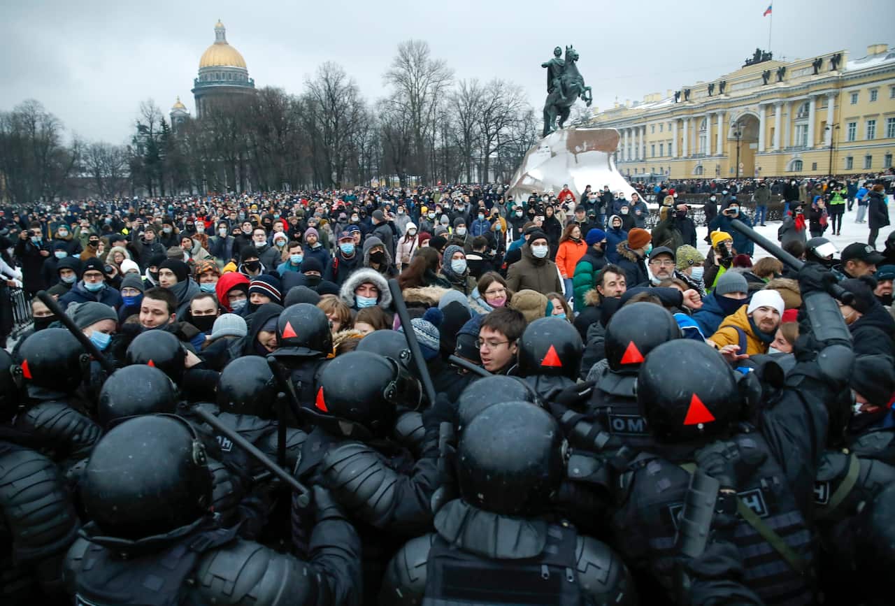 People clash with police during a protest against the jailing of opposition leader Alexei Navalny in St. Petersburg, Russia, Saturday, Jan. 23, 2021.