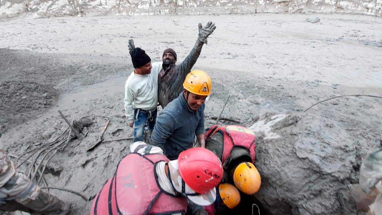 This photograph provided by Indo Tibetan Border Police (ITBP) shows a man reacting after he was pulled out from beneath the ground by ITBP personnel during rescue operations after a portion of Nanda Devi glacier broke off in Tapovan area of the northern s