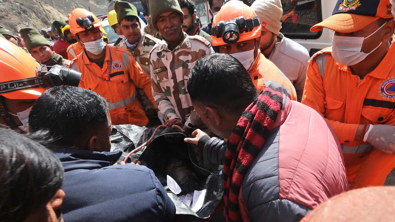 Relatives of a missing person try to identify the mortal remains as National Disaster Response Force (NDRF) conduct the rescue operation near the damaged Dhauliganga hydro power project