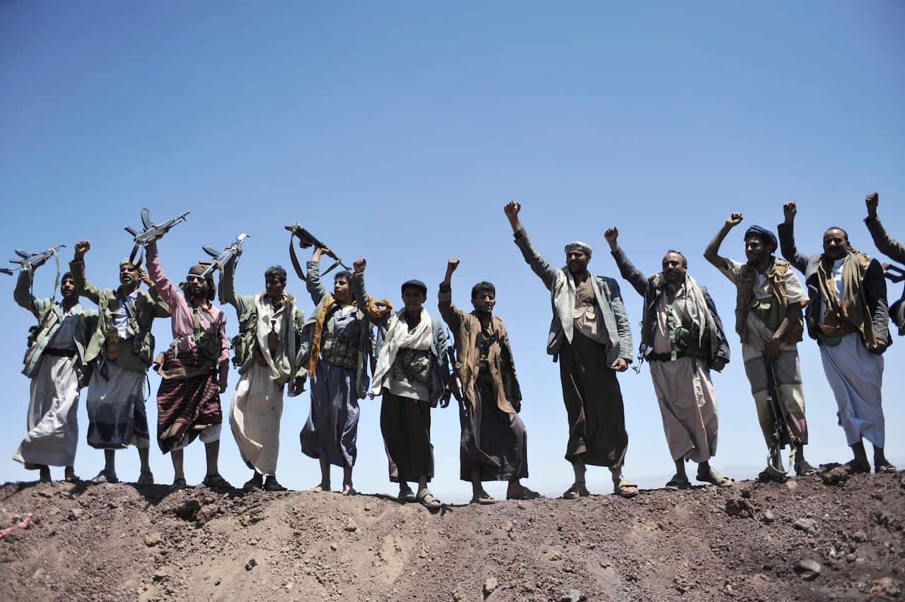 FILE - In this Sept. 22, 2014 file photo, Hawthi Shiite rebels chant slogans at the compound of the army's First Armored Division, after they took it over, in Sanaa, Yemen. Yemens war began in September 2014, when the Houthis seized the capital Sanaa. Sa