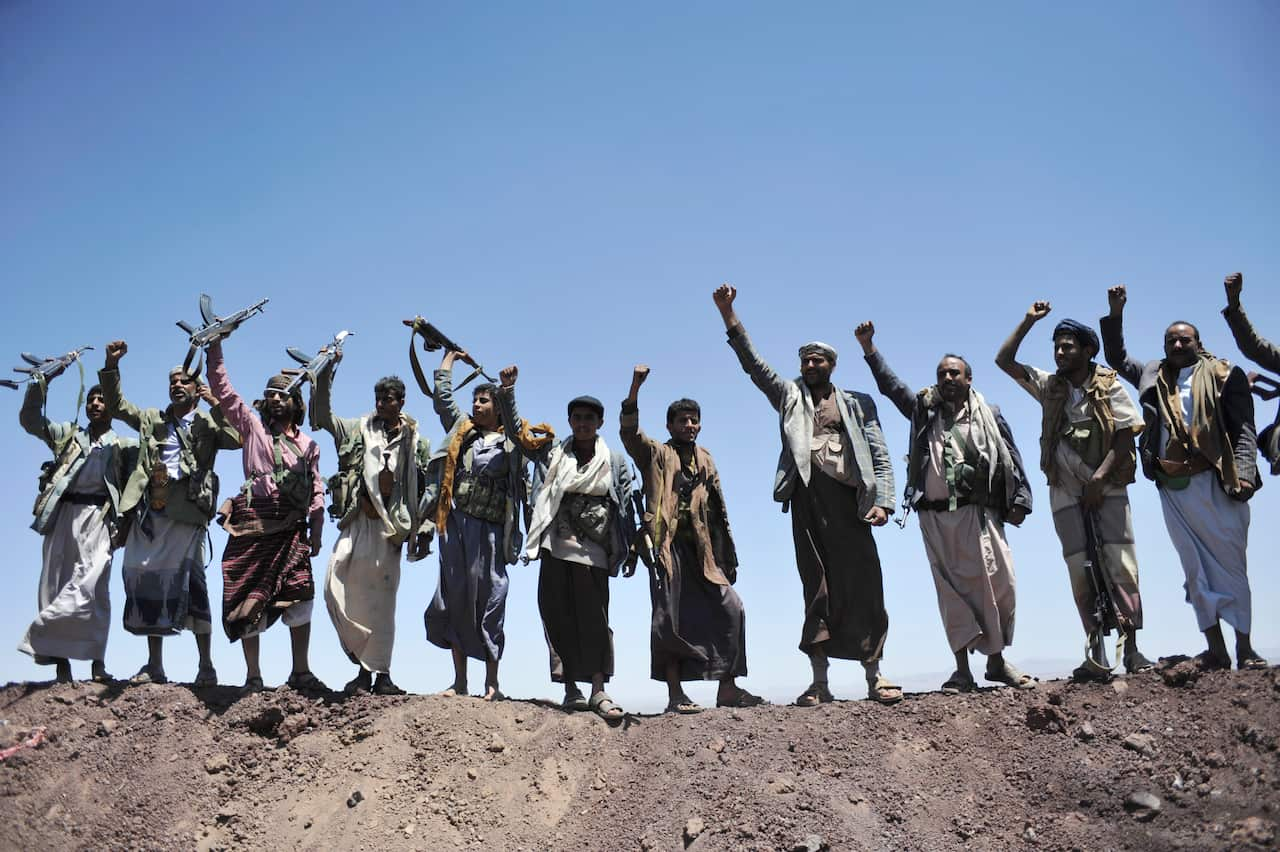 FILE - In this Sept. 22, 2014 file photo, Hawthi Shiite rebels chant slogans at the compound of the army's First Armored Division, after they took it over, in Sanaa, Yemen.  Yemens war began in September 2014, when the Houthis seized the capital Sanaa. Sa