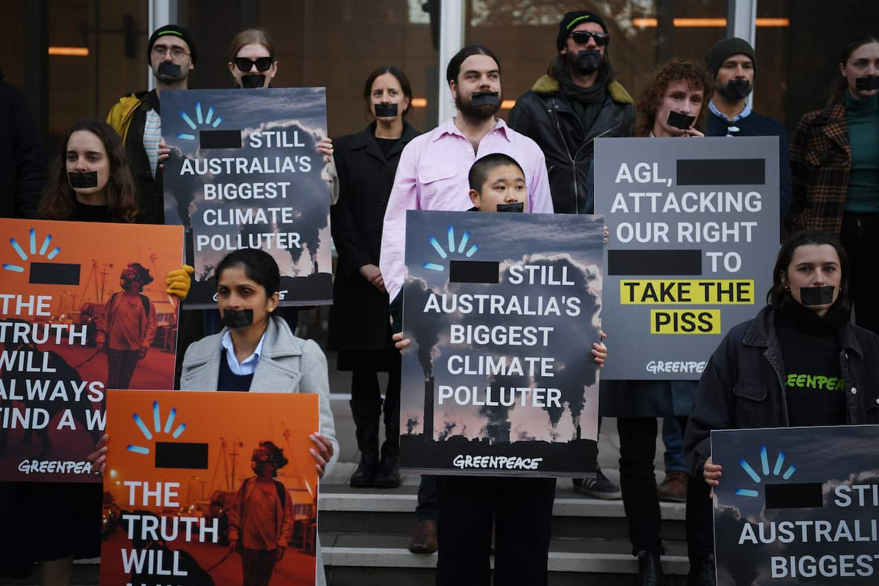 Greenpeace campaigners protest outside the The Federal Court of Australia, in Sydney, Wednesday, June 2, 2021. Energy giant AGL are seeking to have their logo removed from a Greenpeace pollution campaign.  (AAP Image/Dean Lewins) NO ARCHIVING