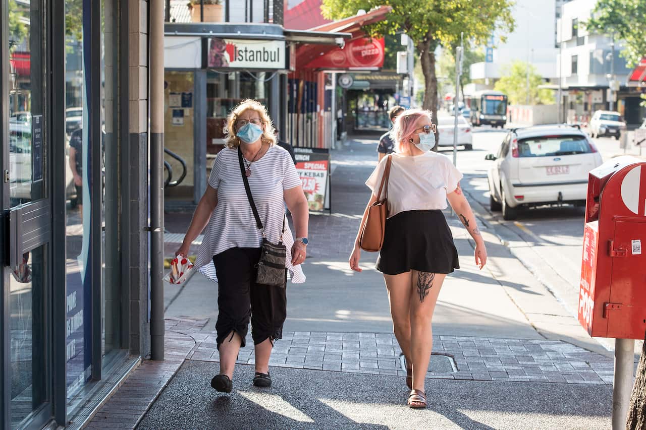 People are seen wearing masks, in Darwin, Monday, August 16, 2021. 